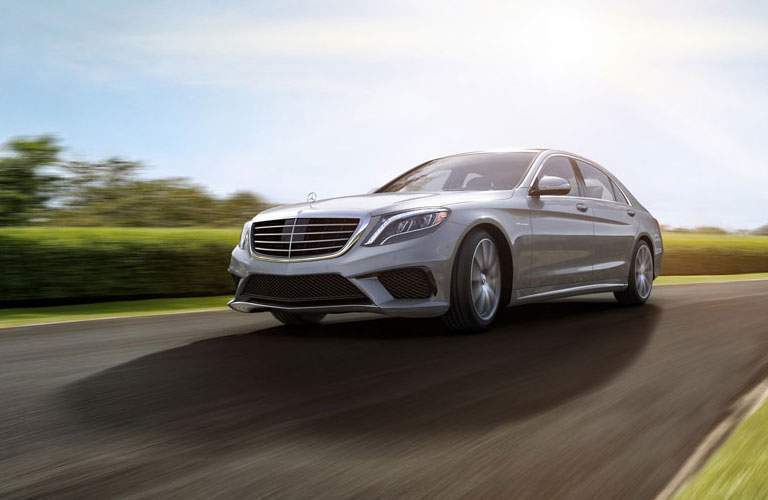 2017 Mercedes-Benz S-Class sedan driving past a green forest