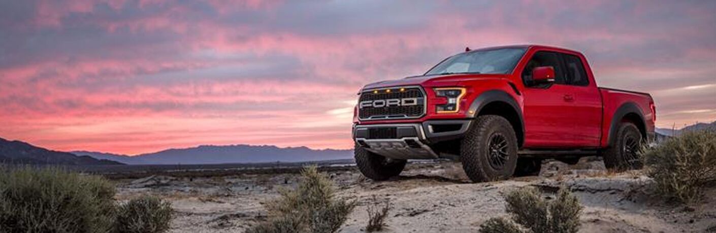 Red 2019 Ford F-150 Raptor parked on desert landscape