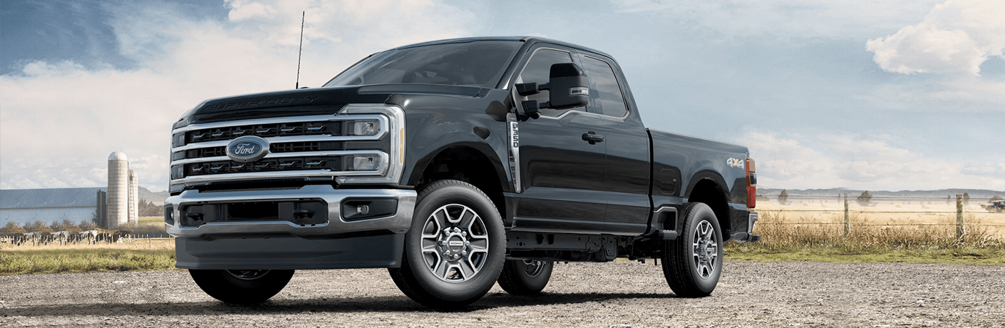 A close up of the 2023 Ford F-350 Super Duty Lariat parked on a smooth terrain