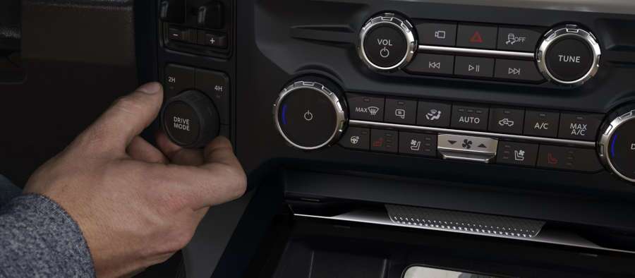 A man using the drive mode control in a Ford Super Duty truck