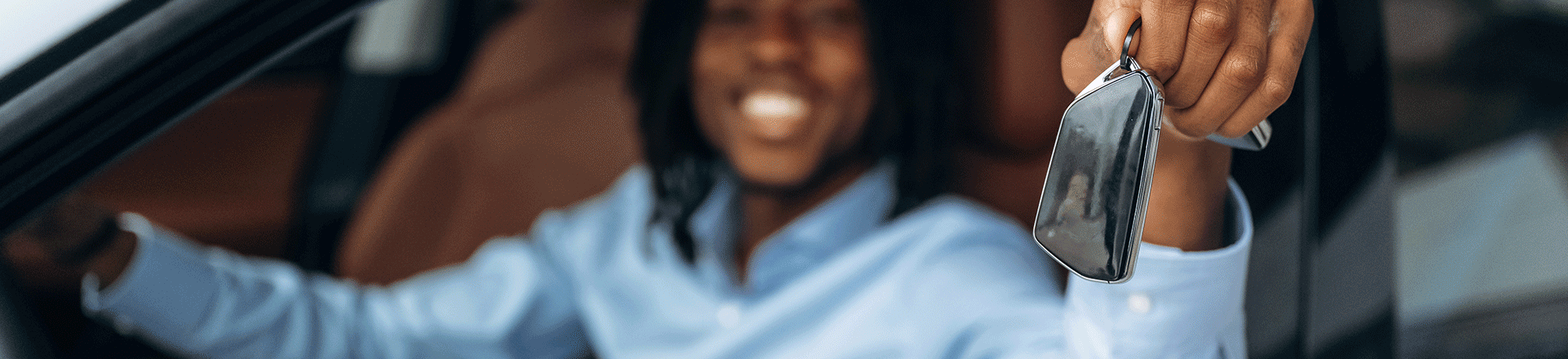 Man Holding Car Keys Out for Vehicle Trade-in
