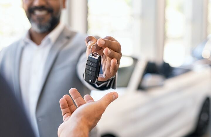 Car Salesman Giving Keys to a customer