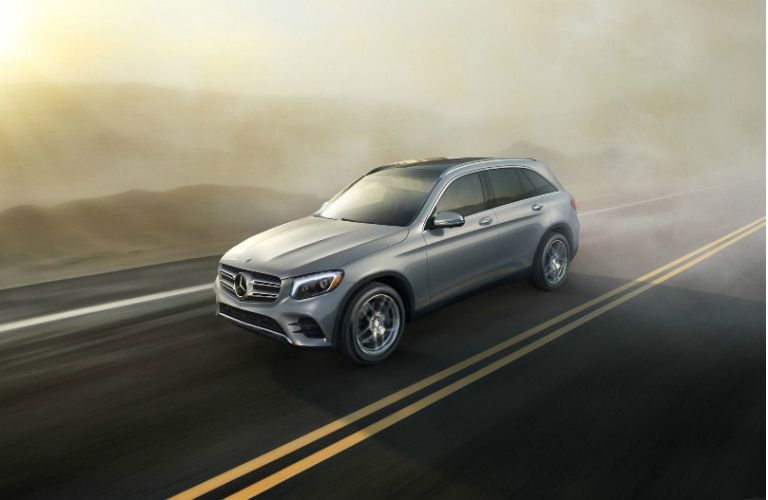 silver Mercedes-Benz SUV driving on road