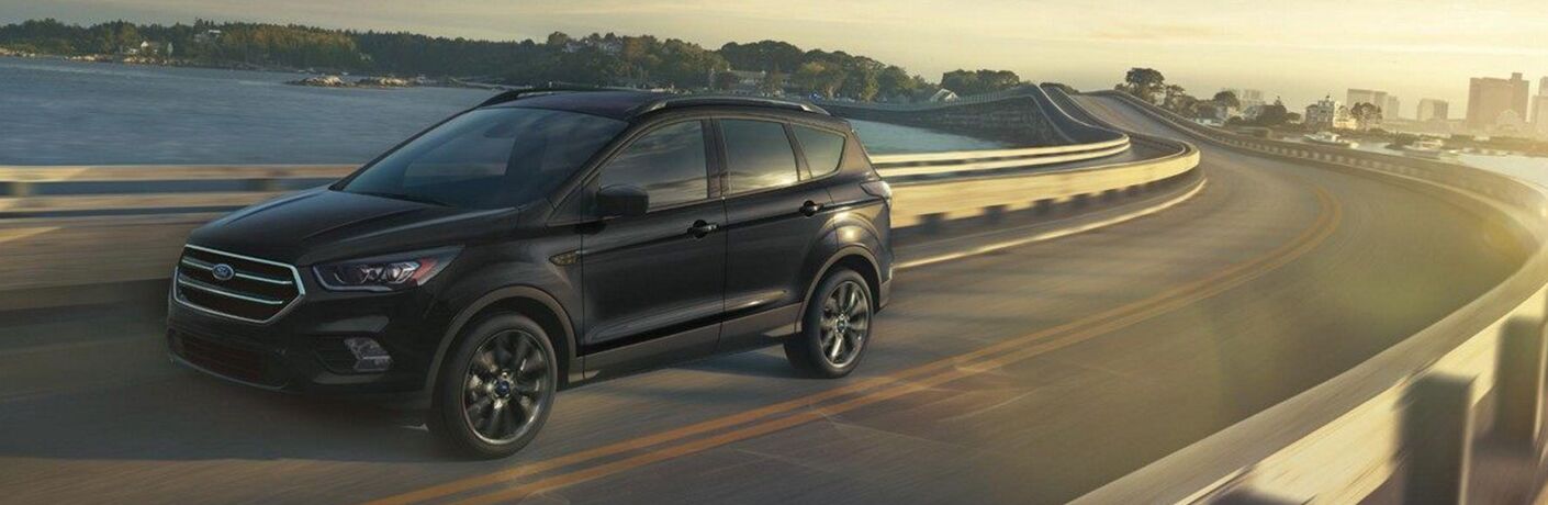 Black 2019 Ford Escape driving over bridge