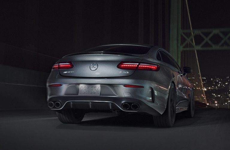 Rear view of the 2023 Mercedes-AMG E 53 Coupe driving on a bridge
