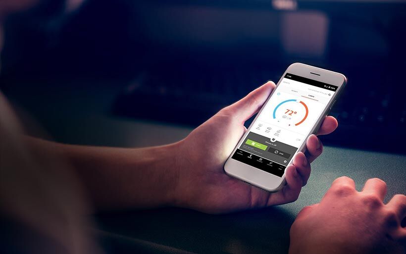 Someone using Kia's UVO app on a smartphone
