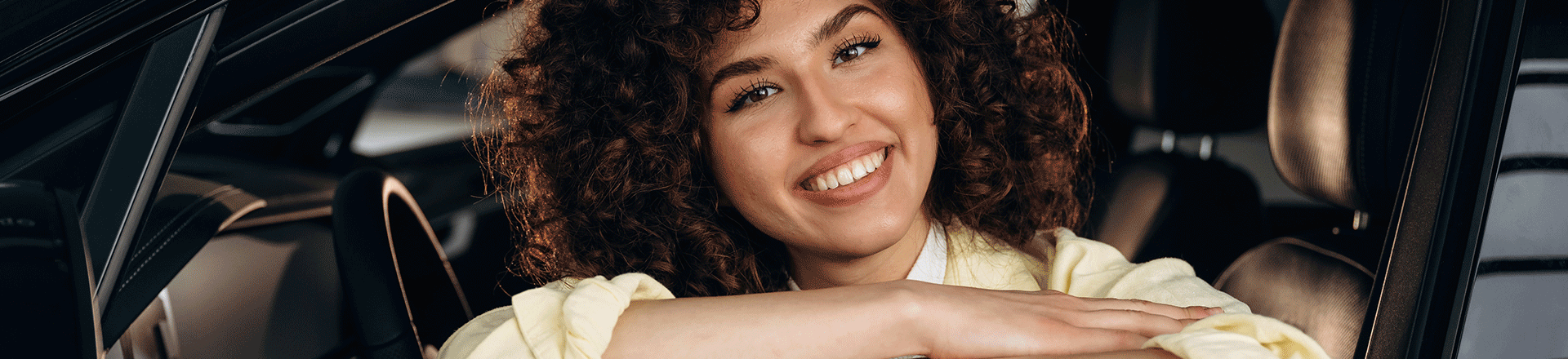 Smiling Woman Seated inside a Vehicle Advantage Motors Customer Reviews