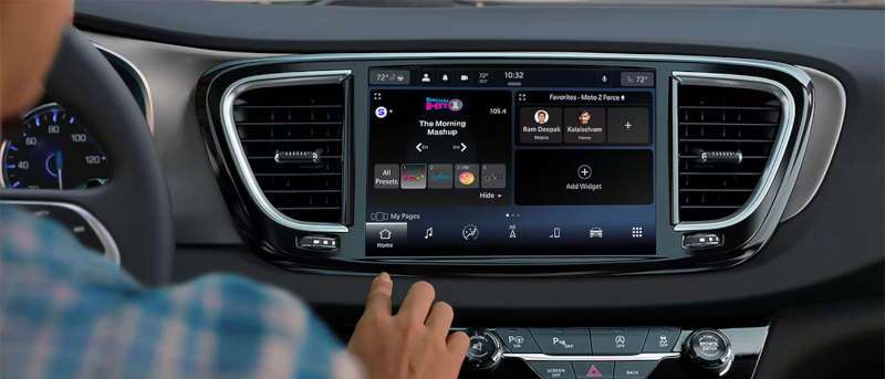 A man using the large infotainment center in the 2025 Chrysler Voyager