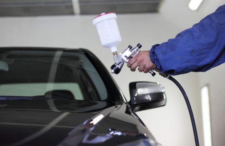 A service person working on a car
