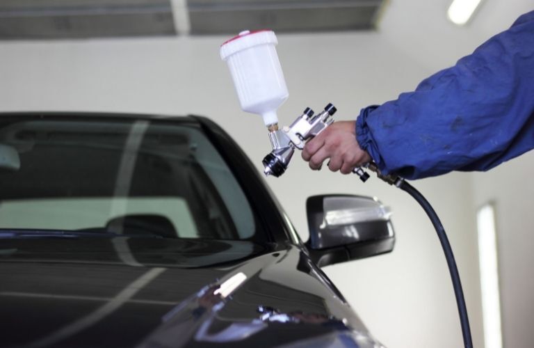 Mechanic Painting a Car