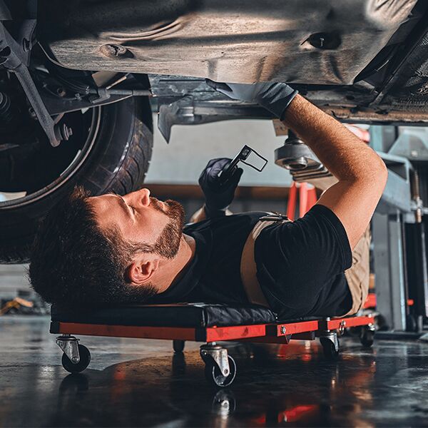Technician working underneath vehicle