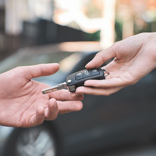 Car keys being handed over to another person