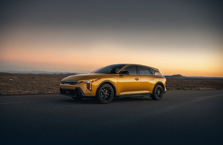 2026 Kia K4 side view on a road at night