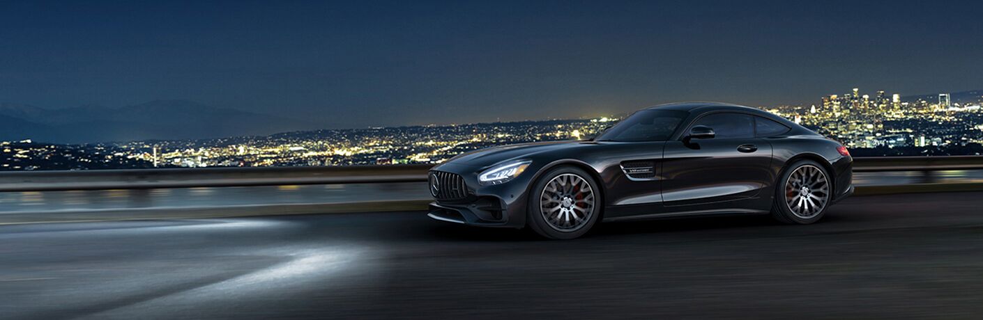 2022 MB GT exterior rear fascia drvier side in front of city at night