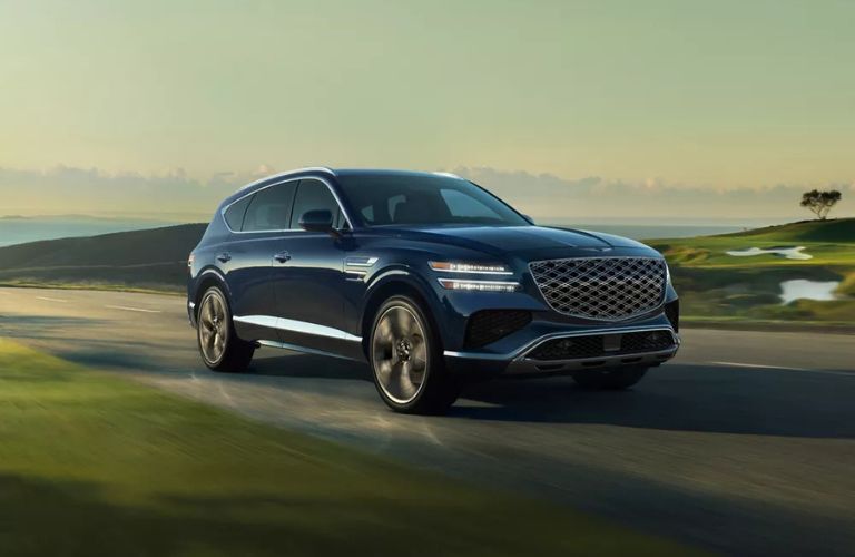 diagonal front view image of a Genesis SUV on a road