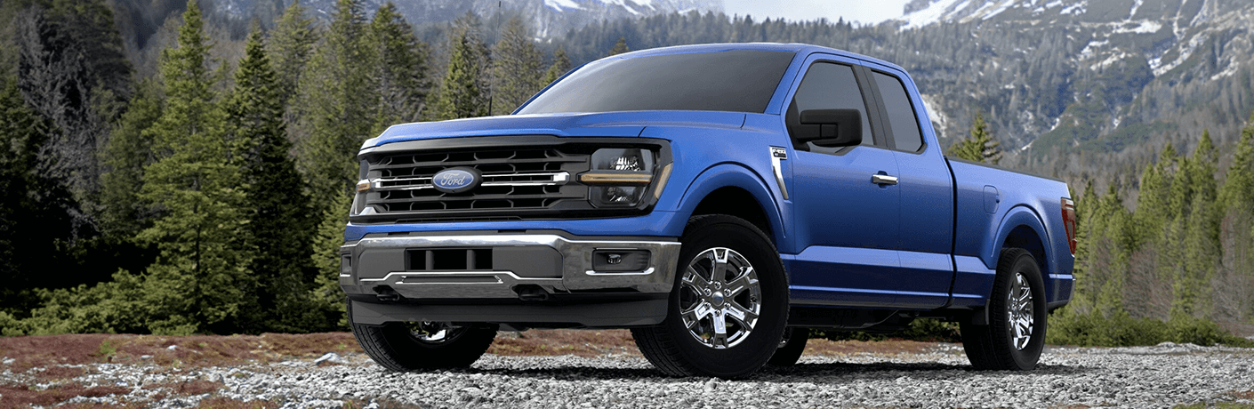 2024 Ford F-150 XLT in blue in front of a mountain