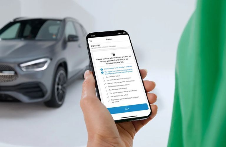 A man remotely starting the engine via the Mercedes-Benz App