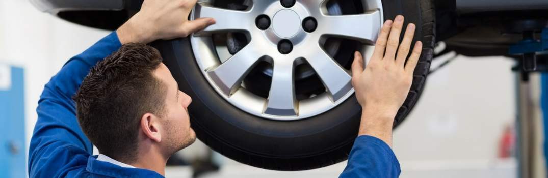Man checking a wheel and tire