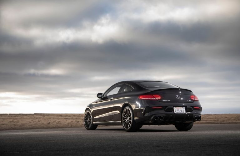 2021 MB C-Class Coupe exterior rear fascia driver side with cloudy sky