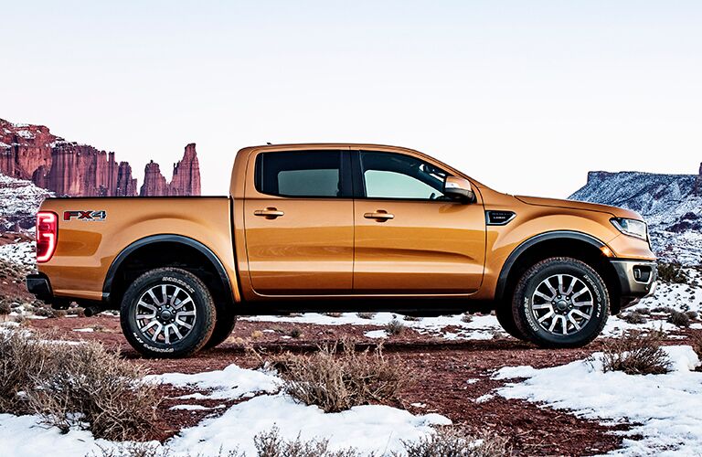 Profile view of orange 2019 Ford Ranger parked in snow