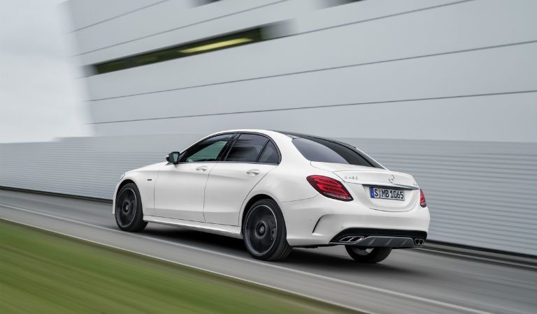 white Mercedes-Benz C-Class driving