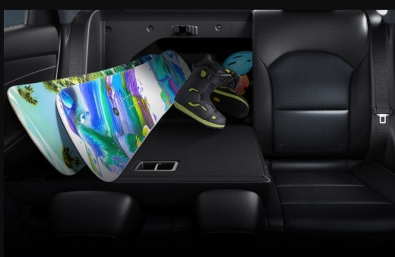 surf board and shoes placed in the middle of the rear seats of the 2021 Kia Forte