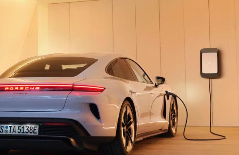 rear view of the 2025 Porsche Taycan being charged