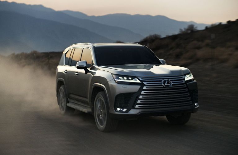 A 2024 Lexus LX speeding on a sandy terrain
