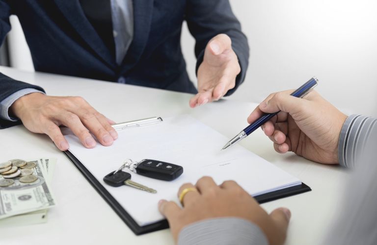 Hands of two people signing a paper
