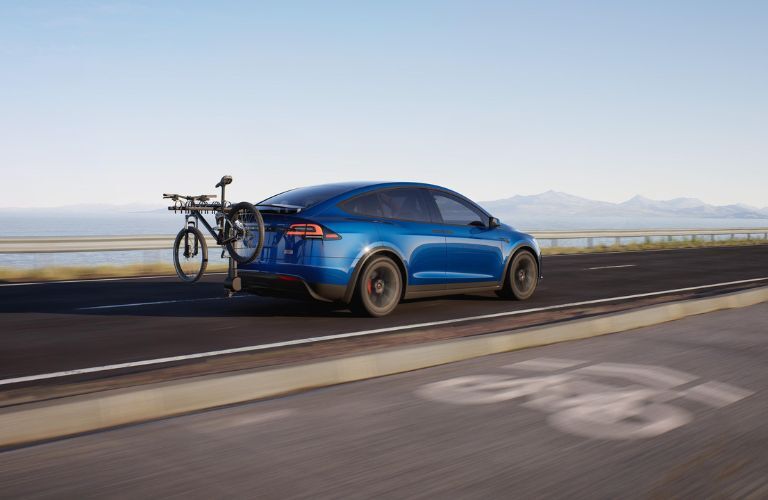 side view image of Tesla car on a road