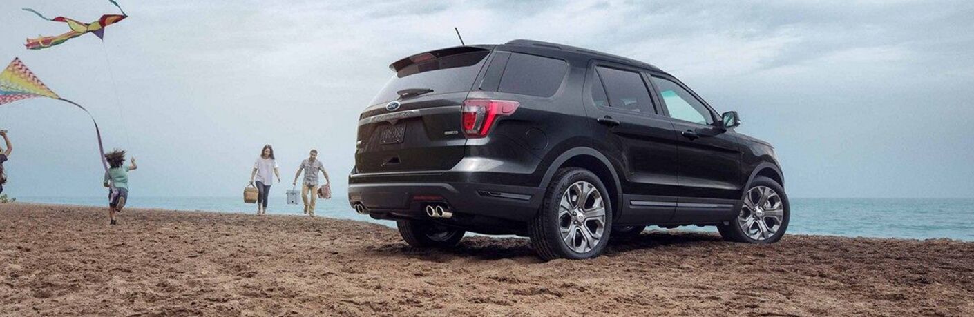 Rear view of black 2019 Ford Explorer Limited parked at beach