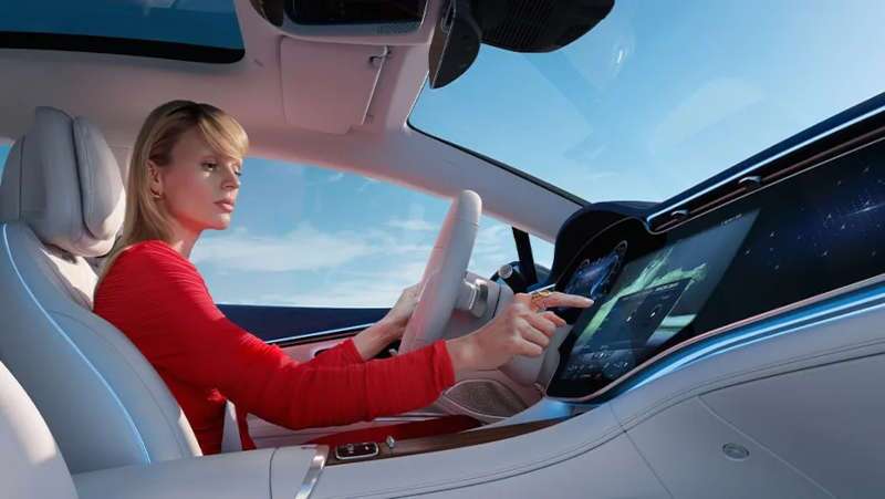 A woman using the MBUX Hyperscreen in the 2025 Mercedes-Benz EQS 450 4MATIC® SUV