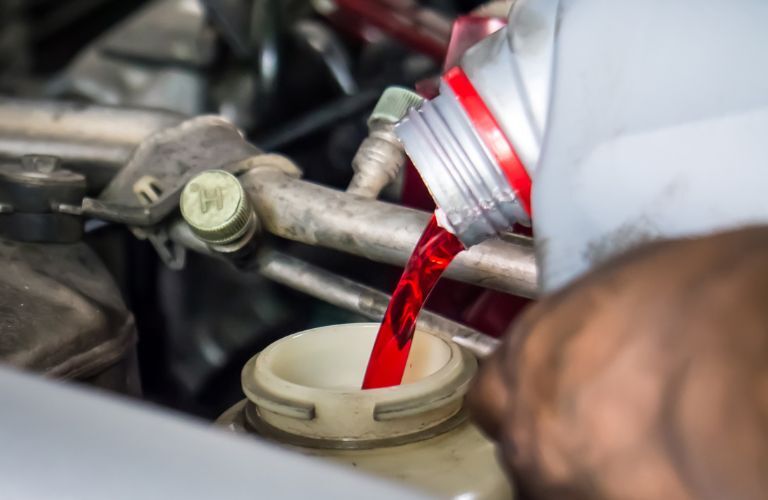 Transmission fluid being poured into the vehicle