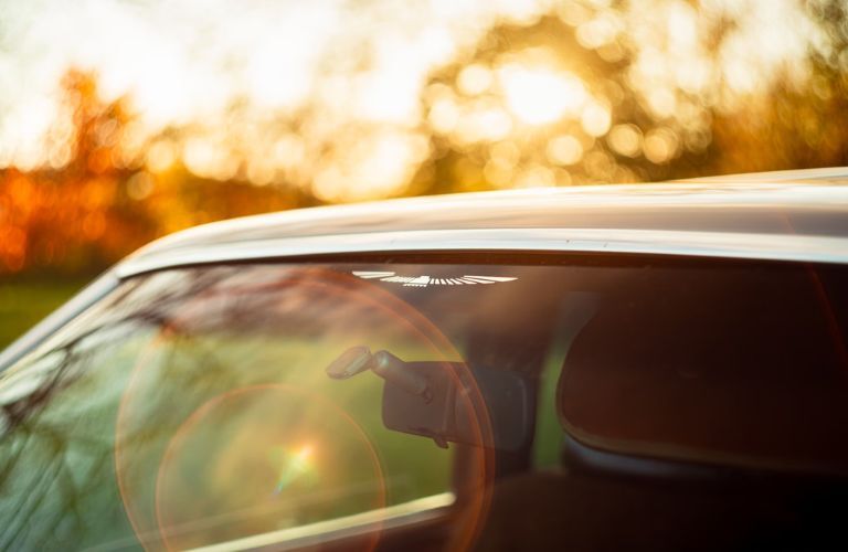 a sun shining on a car