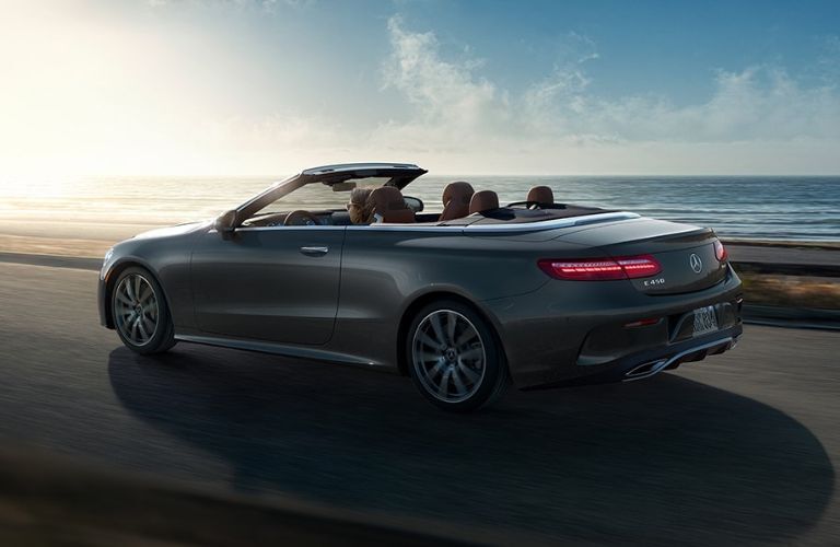 Rear three-quarter view of the 2023 Mercedes-Benz E-Class Cabriolet driving on road