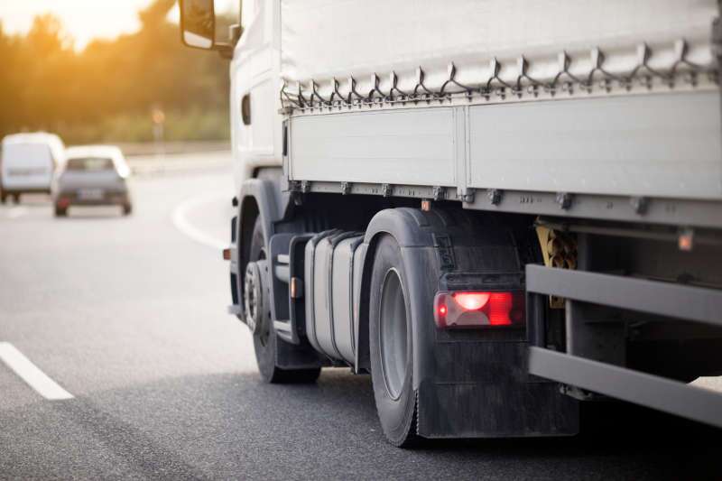 A large commercial truck driving on the highway