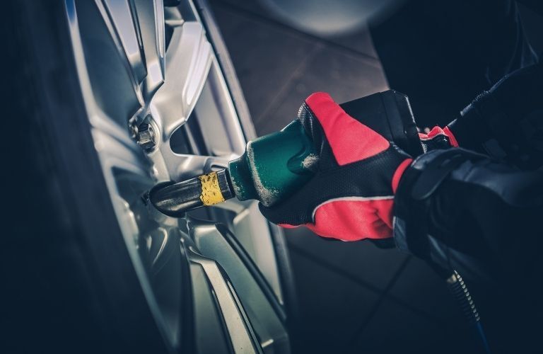 A mechanic working on a tire