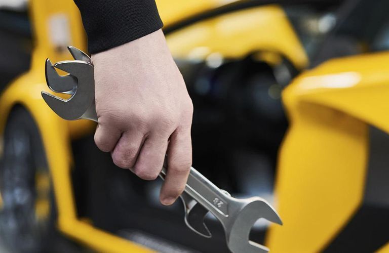 Mechanic holding service wrench