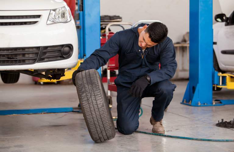 man checking a tire off the car