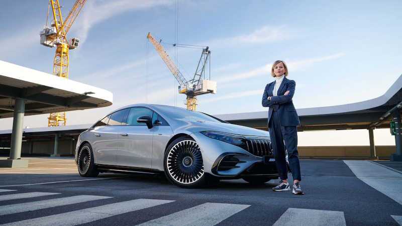 A woman standing in front of her new AMG® EV