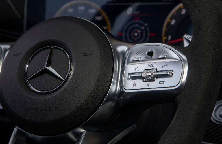 close up of Mercedes-Benz icon on a steering wheel