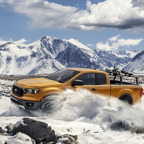 ford truck driving through snow