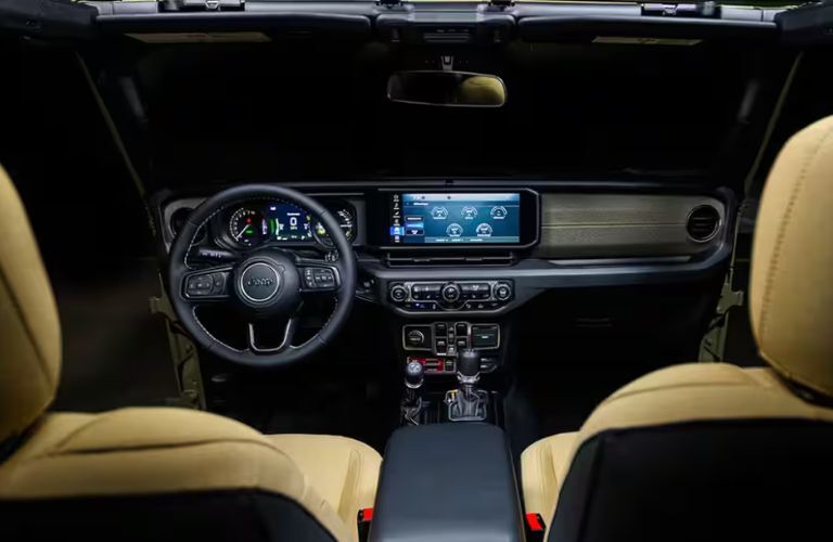 interior cabin steering and dashboard of the 2025 Jeep Wrangler