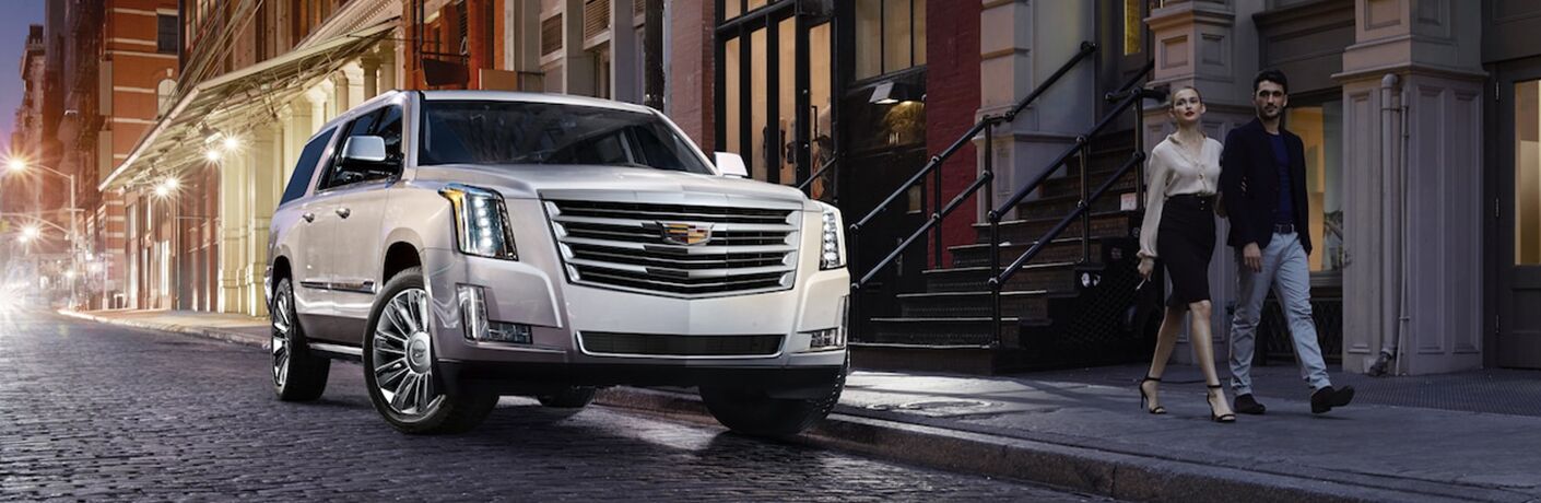 people walking near 2019 Cadillac Escalade