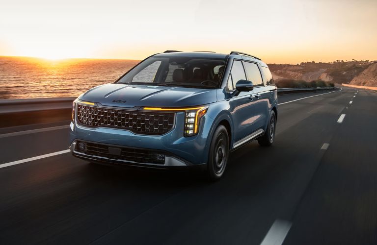2026 Kia Carnival MPV Blue on the road