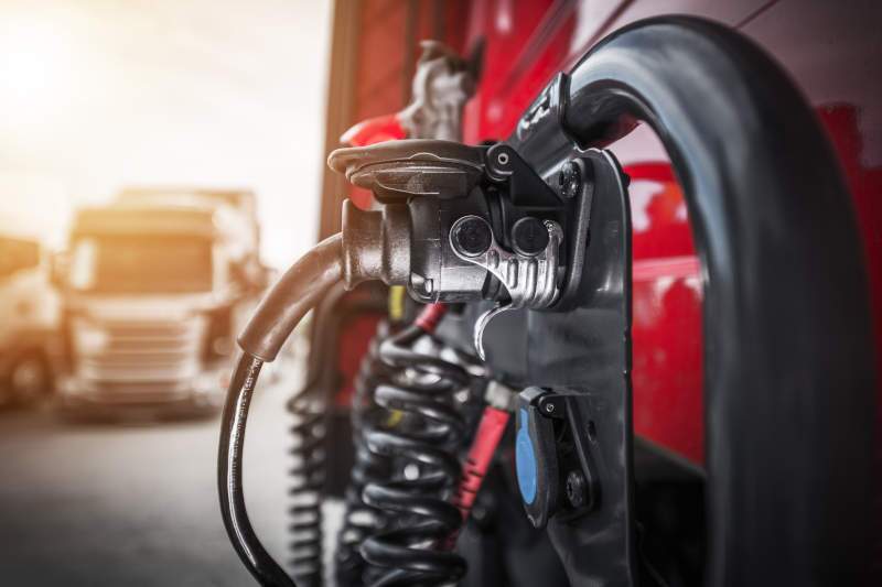 An EV semi truck charging at a charging station.