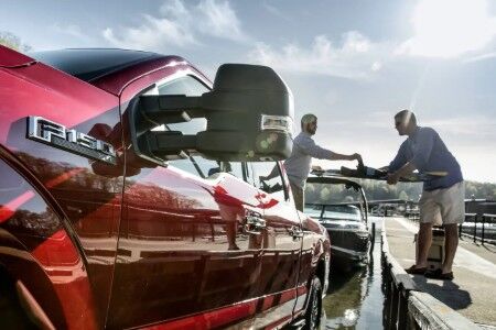 Red 2019 Ford F-150 XLT towing boat to dock