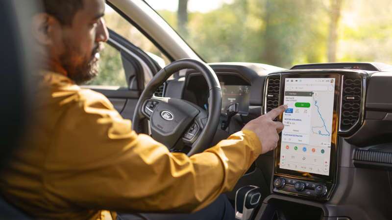 A man using the infotainment system in the 2025 Ford Ranger Lariat.