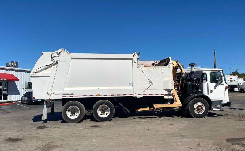 A used Autocar garbage truck from Dirt Cheap Truck Sales in Tampa, FL.