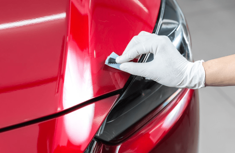 A mechanic painting a vehicle